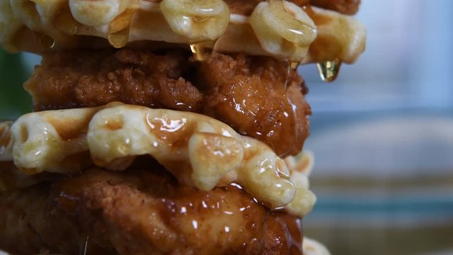 Drops of Syrup Fall from Chicken and Waffles Close Up