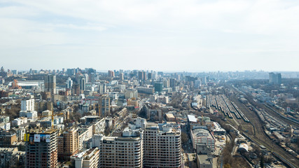 Fototapeta na wymiar Aerial view of Kiev city center, railway tracks and construction of high-rise buildings, Ukraine
