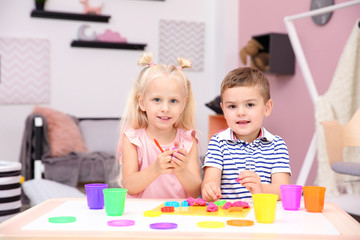 Fototapeta premium Cute little children modeling from playdough at home