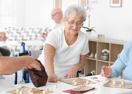 Senior people playing lotto at care home