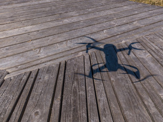 Aerial view of wooden walkways with shadow from quadrocopter 