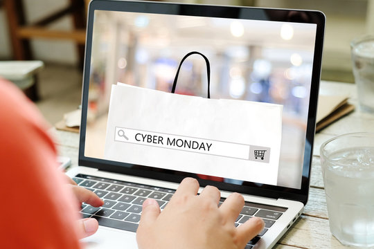 Hands typing laptop computer with cyber monday sale on search bar banner background, Online shopping, business and technology