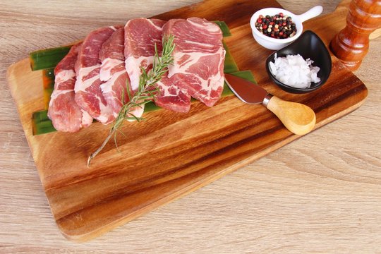 Raw pork steaks with salt and pepper