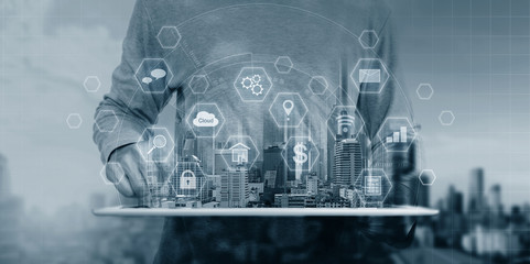 a man using digital tablet and interface online application icons