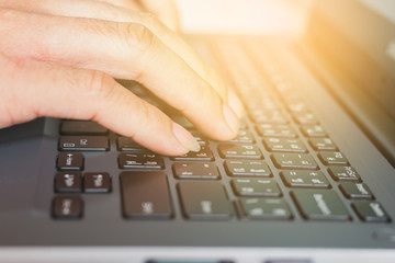 business male's hands working and typing on laptop keyboard