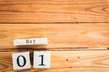 Wooden Block calendar for Labour Day, May 1 with blank space on wooden table background texture.