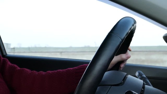 Woman With Steering Wheel Driving In Sunny Day