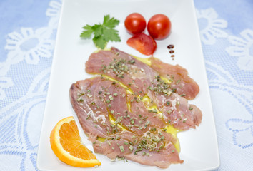 A delicious fresh Mediterranean tuna carpaccio dressed with olive oil, chives, parsley and at drops of orange juice. 