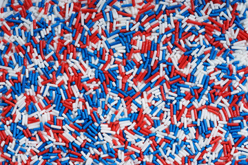 Sugar sprinkle dots in blue, white and red colors.