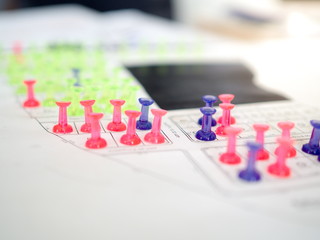 Colorful push pins marking for real estate resevation