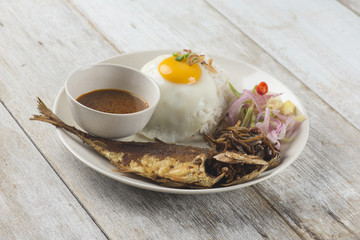 fried fish with rice with spices and curry