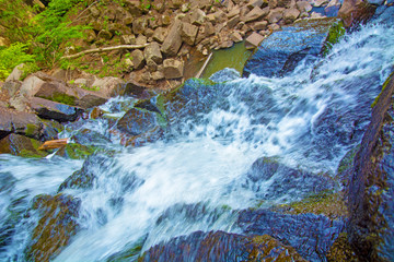 view from the top of the waterfall falling down, forest landscape with a waterfall, where begins...