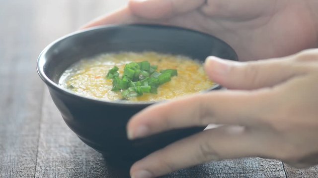 Serving a bowl rice porridge
