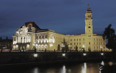 Oradea City Hall on embankment in twilight
