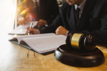 business people and lawyers discussing contract papers sitting at the table. Concepts of law, advice, legal services. in morning light
