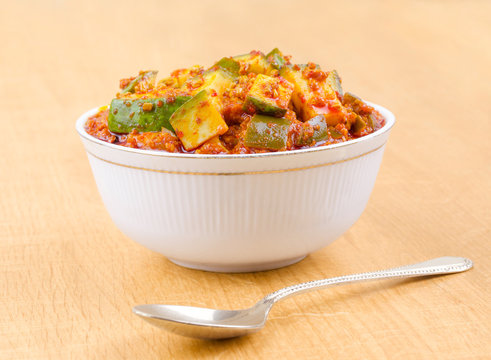 Indian Traditional Raw Mango Pickle Also Know as Aam Ka Achar or Kari Ka Achar on Wooden Background