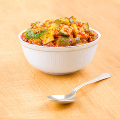 Indian Traditional Raw Mango Pickle Also Know as Aam Ka Achar or Kari Ka Achar on Wooden Background