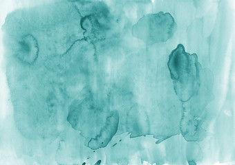 Abstract aquamarine watercolor background. The color splashing on the paper. It is a hand drawn.