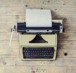 Old Russian typewriter over retro wooden background. Vintage equipment.