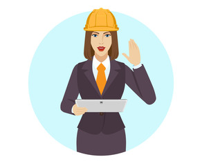 Businesswoman in construction helmet holding a digital tablet PC and greeting someone with his hand raised up