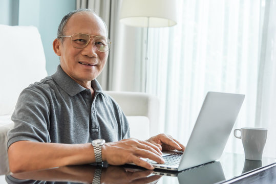 Asian Senior man using laptop.