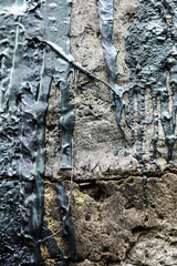 Concrete surface with the streaks of black tar