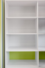 Closeup of empty white wooden bookshelf in modern room