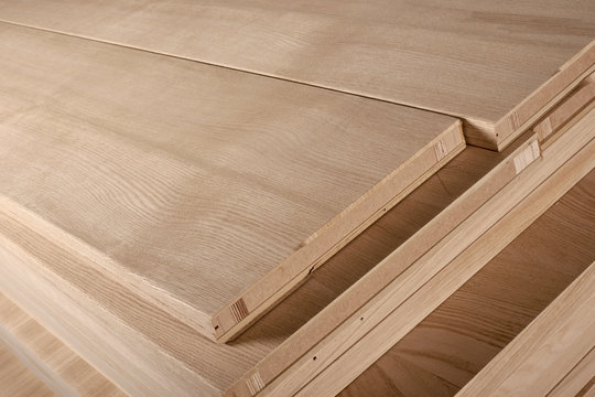 Stacked timber boards for production wooden doors on factory