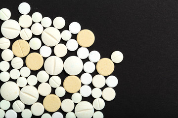 tablets and pills on dark background