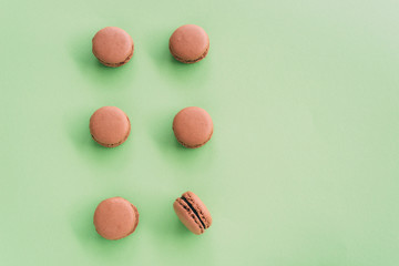 Flat lay of macarons on green background