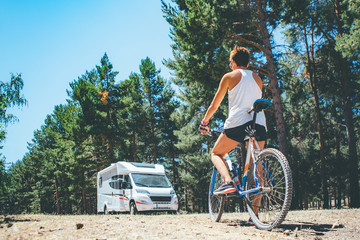 Motor home and girl with bicycle