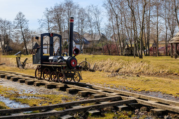 a toy train from a tree stands on the rails