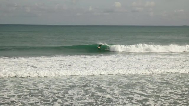 Surfer catches big wave on Vieques Island, Puerto Rico