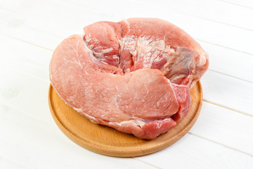 Fresh pork on a cutting board ready to cook. pork meat on white wooden background