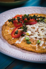 Omelet, fried chicken eggs with fresh vegetables