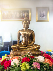 Golden buddha statue on flower