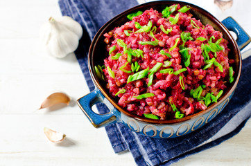 Buckwheat stewed with beetroot in a bowl on a wooden table