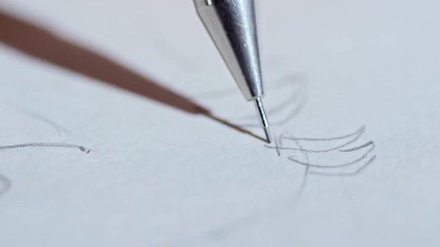 Extreme close up of unrecognizable graphic designer using gray pencil when drawing sketch for future picture