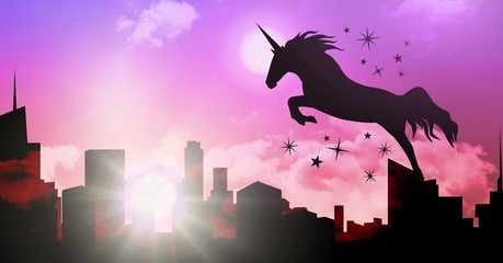 Unicorn silhouette jumping over city