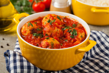 Chicken meatballs with tomato sauce. Served with rice.