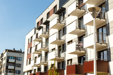 Obraz premium Exterior of new apartment buildings on a blue sky background. Real estate business concept.