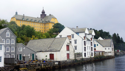 Fototapeta na wymiar Scenic view of old houses in norwegian town before rain, beautiful city centre, Alesund, Norway