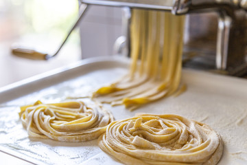 fresh pasta tagliatelle made with a traditional machine