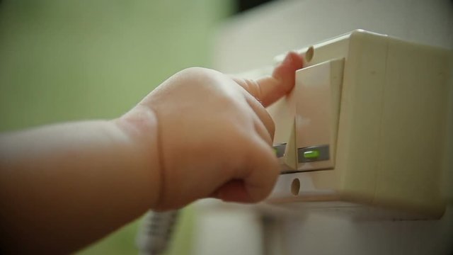 Baby's Hand plays with lelectric ight switch