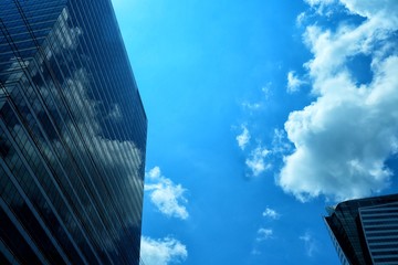 Fototapeta na wymiar Modern Building with Clouds and Blue Sky Background.