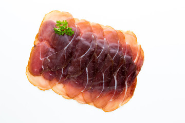 Italian prosciutto crudo or jamon. Raw ham. Isolated on white background