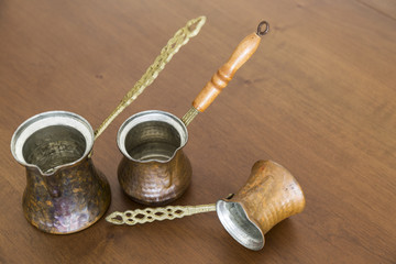 Obraz na płótnie Canvas copper coffee pot in the wooden background. Kitchenware for concept.