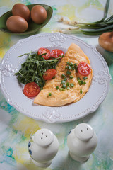 Omelet, fried chicken eggs with fresh vegetables