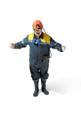 The studio shot of senior bearded male miner standing at the camera on a white background.