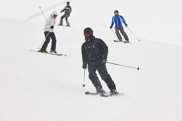 Skiers under the snow. Winter sport. Ski slope